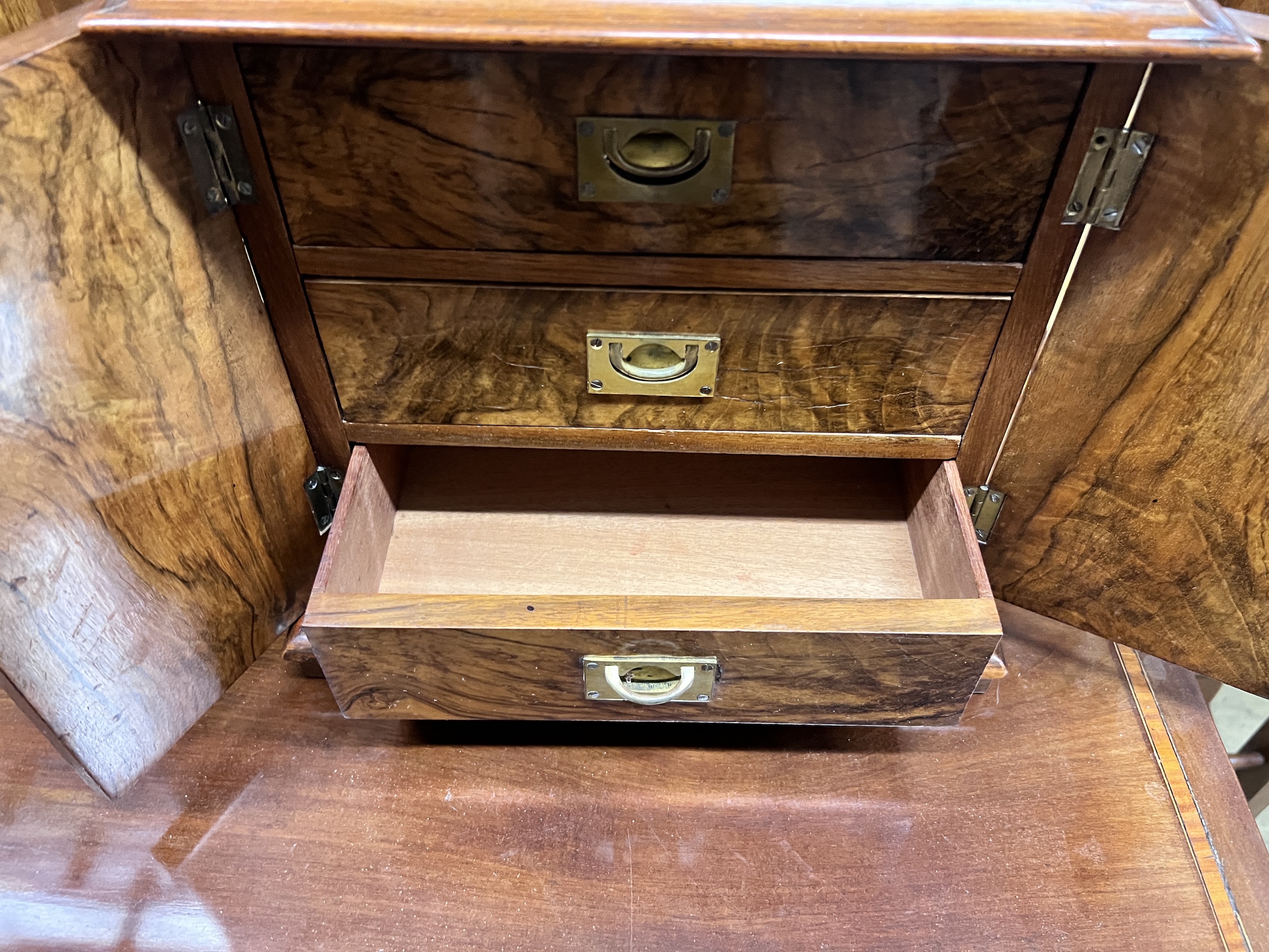 A Victorian figured walnut table cabinet fitted three drawers, width 32cm